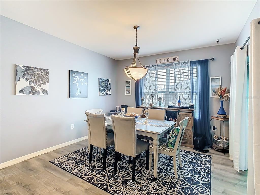 1765 Brockridge Road Kissimmee, FL 34744 - Photo 13 of 45 a view of a dining room with furniture window and wooden floor