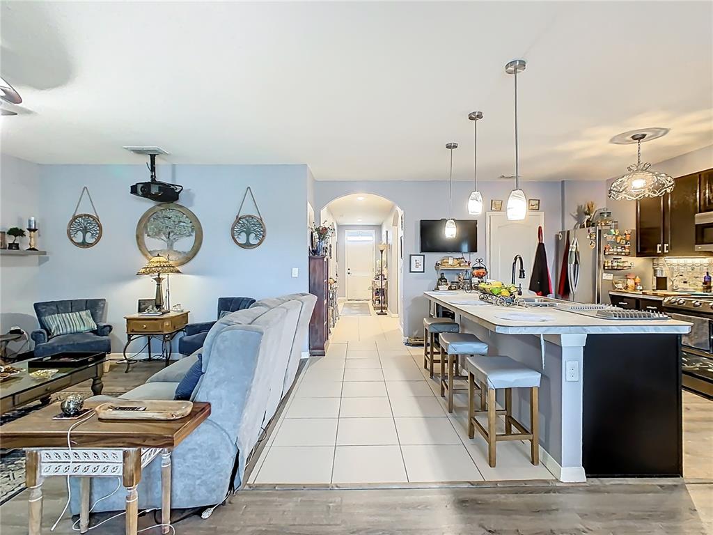 1765 Brockridge Road Kissimmee, FL 34744 - Photo 14 of 45 a living room with furniture a clock and a table