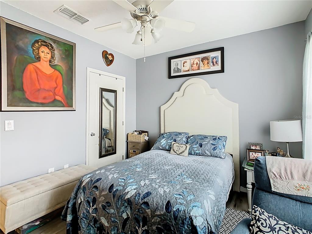 1765 Brockridge Road Kissimmee, FL 34744 - Photo 18 of 45 a bedroom with a bed and painting on the wall