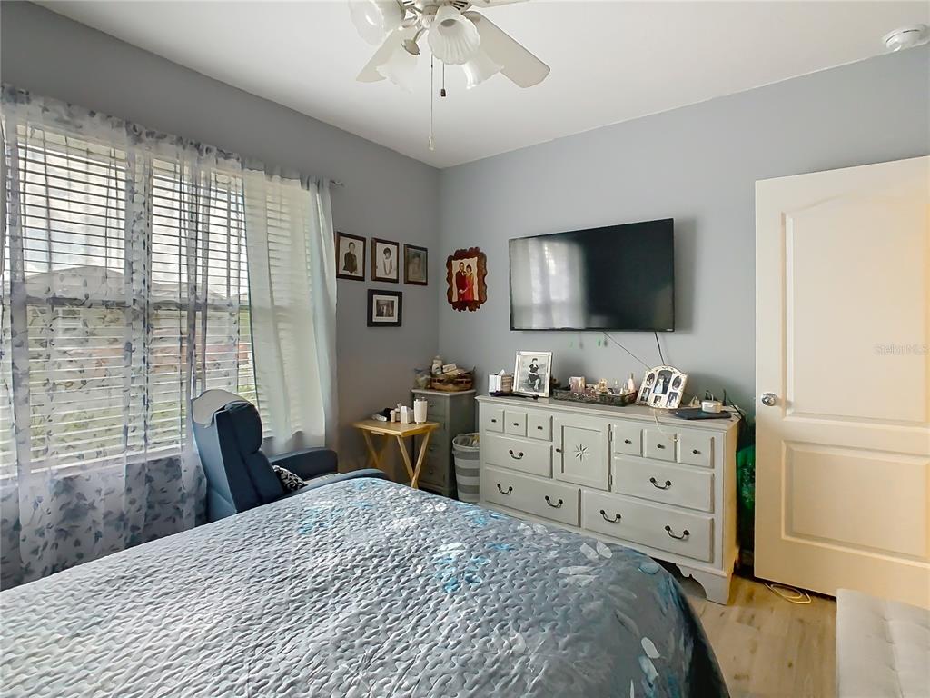 1765 Brockridge Road Kissimmee, FL 34744 - Photo 20 of 45 a bedroom with a bed and a flat screen tv