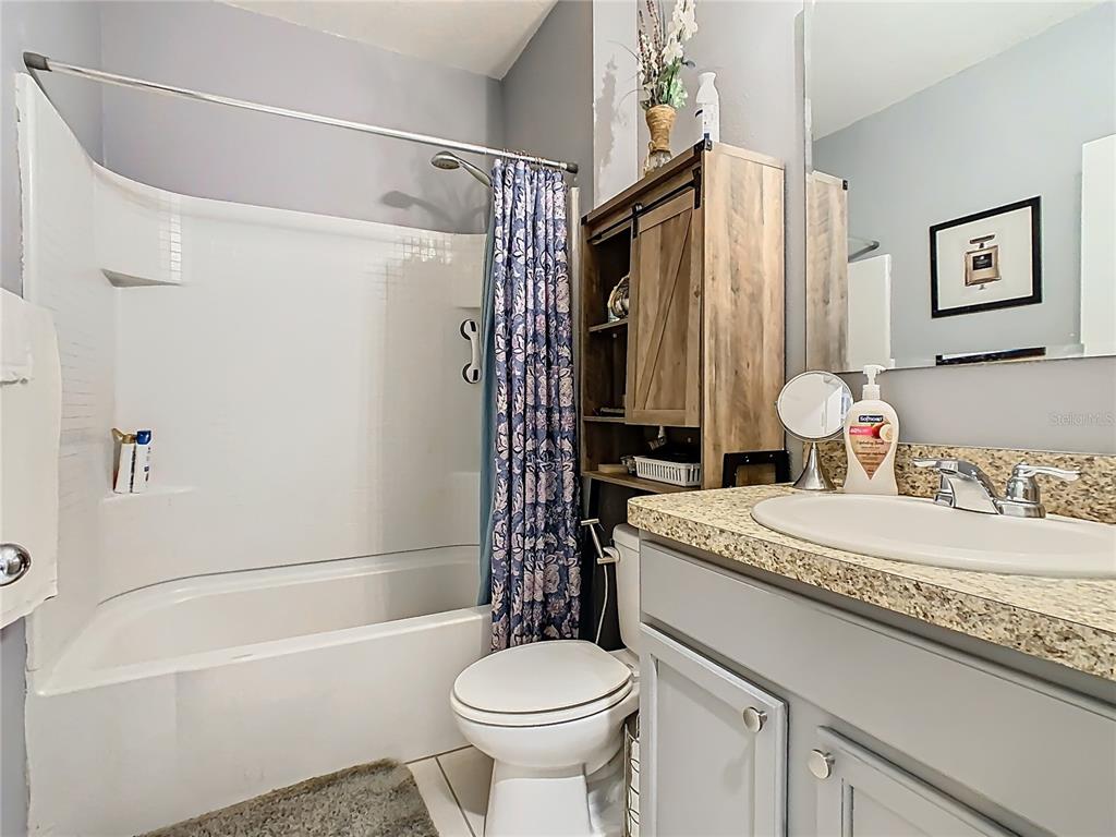 1765 Brockridge Road Kissimmee, FL 34744 - Photo 21 of 45 a bathroom with a sink a toilet and a bathtub