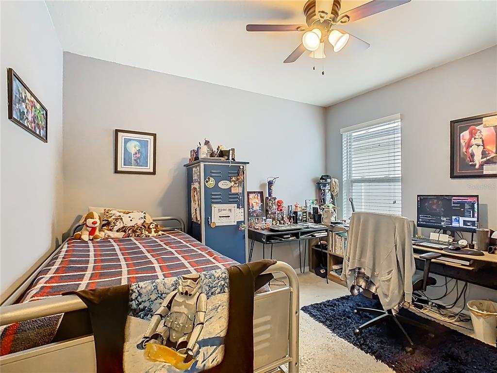 1765 Brockridge Road Kissimmee, FL 34744 - Photo 23 of 45 a bedroom with a bed and a chandelier