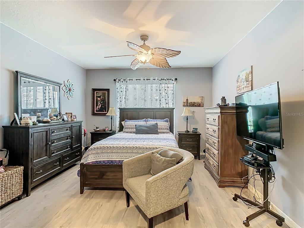 1765 Brockridge Road Kissimmee, FL 34744 - Photo 25 of 45 a bedroom with a bed and a flat screen tv