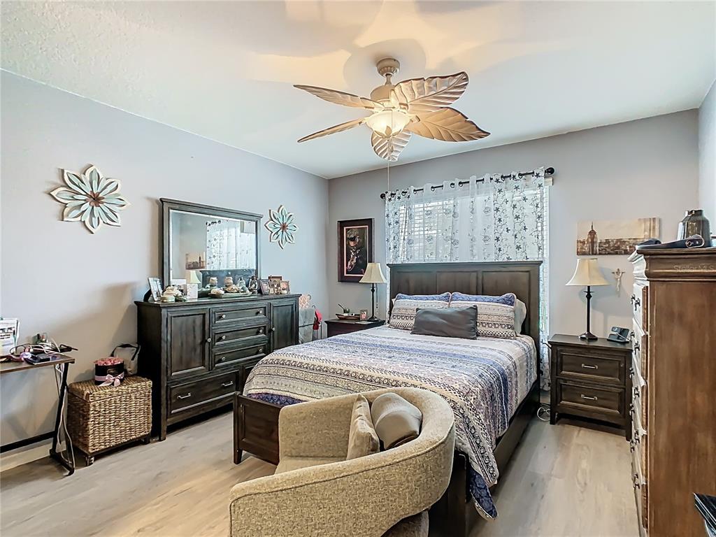 1765 Brockridge Road Kissimmee, FL 34744 - Photo 26 of 45 a bedroom with a bed and wooden floor