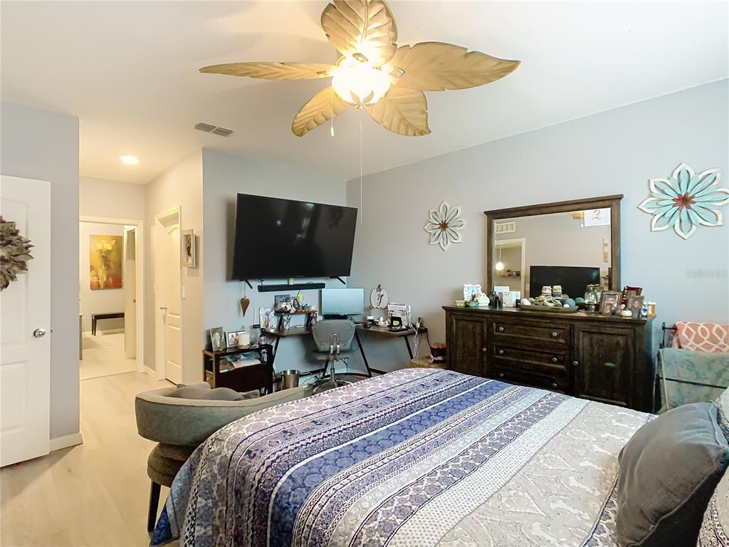 1765 Brockridge Road Kissimmee, FL 34744 - Photo 27 of 45 a bedroom with a bed and a flat screen tv