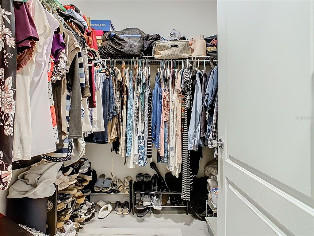 1765 Brockridge Road Kissimmee, FL 34744 - Photo 28 of 45 a view of walk in closet with clothes and shoes