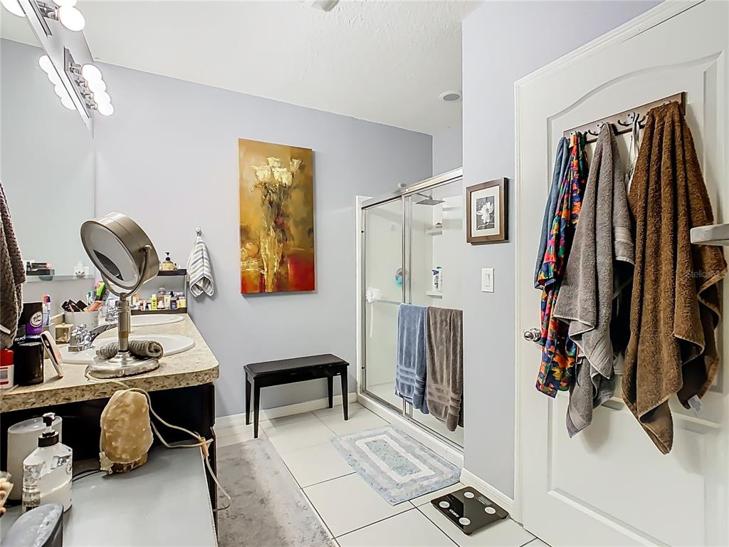 1765 Brockridge Road Kissimmee, FL 34744 - Photo 29 of 45 a view of walk in closet with clothes and shoes