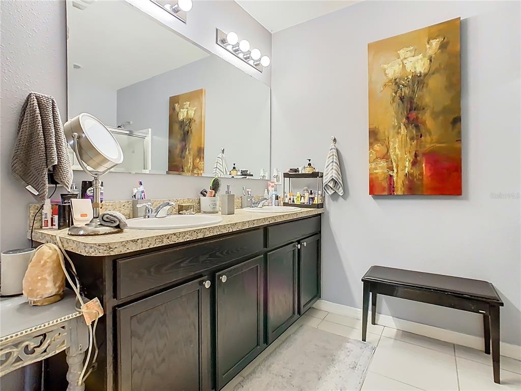 1765 Brockridge Road Kissimmee, FL 34744 - Photo 30 of 45 a bathroom with a sink and a mirror