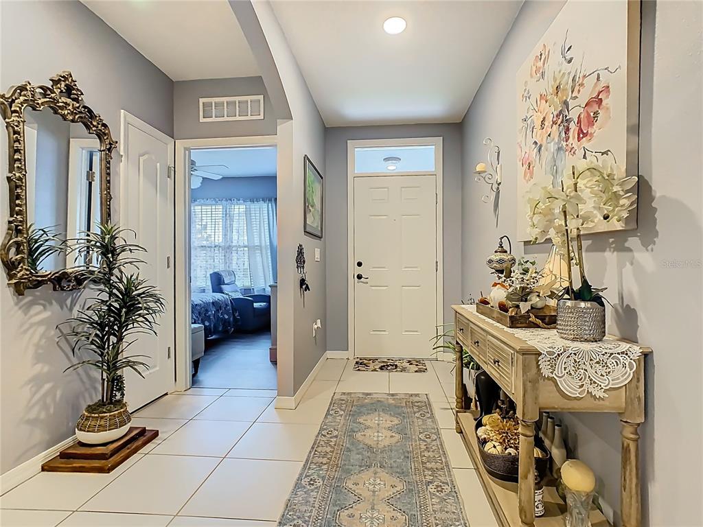 1765 Brockridge Road Kissimmee, FL 34744 - Photo 3 of 45 a view of a hallway and a livingroom with furniture