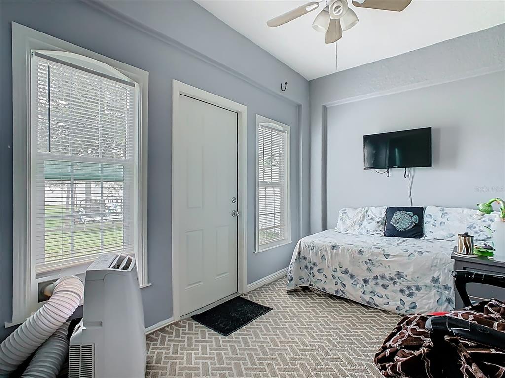 1765 Brockridge Road Kissimmee, FL 34744 - Photo 35 of 45 a bedroom with a bed and a television