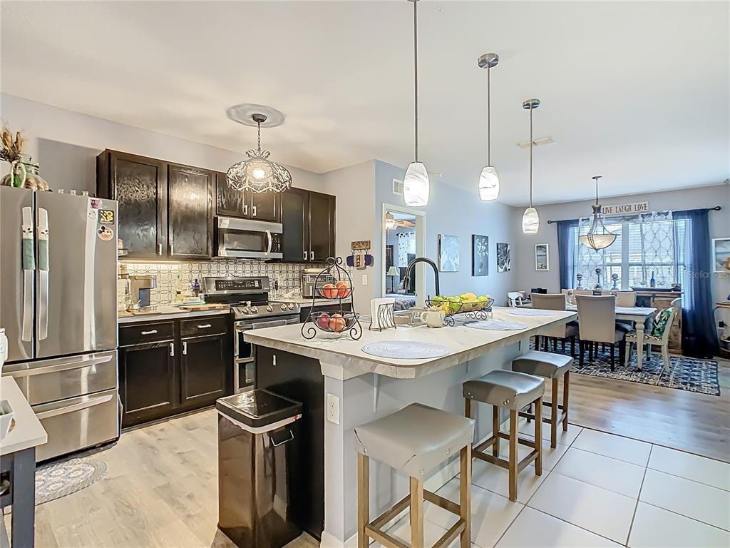 1765 Brockridge Road Kissimmee, FL 34744 - Photo 4 of 45 a kitchen with counter space appliances and chairs