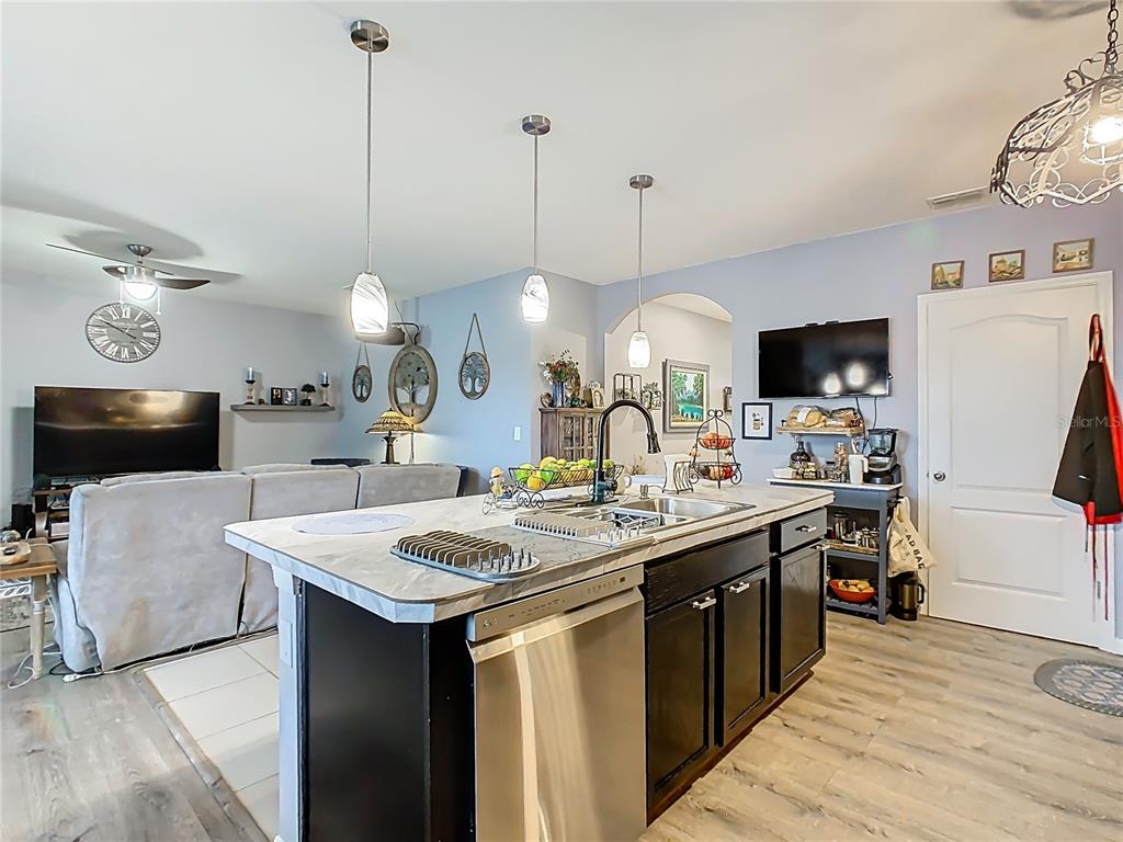 1765 Brockridge Road Kissimmee, FL 34744 - Photo 8 of 45 a kitchen with a sink a counter space appliances and cabinets