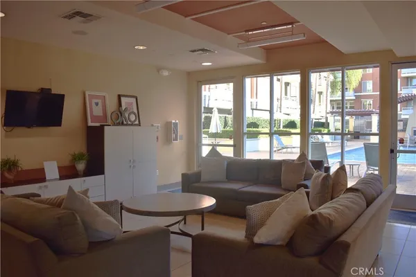a view of a multi story residential apartment building with a yard