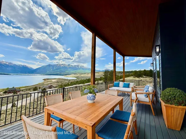 a kitchen with kitchen island granite countertop a refrigerator a stove top oven and a sink with wooden floor