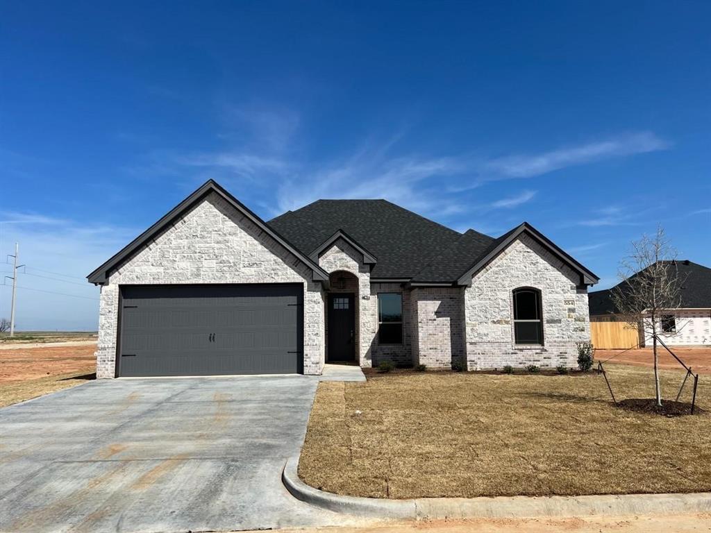 a view of a house with a yard and garage