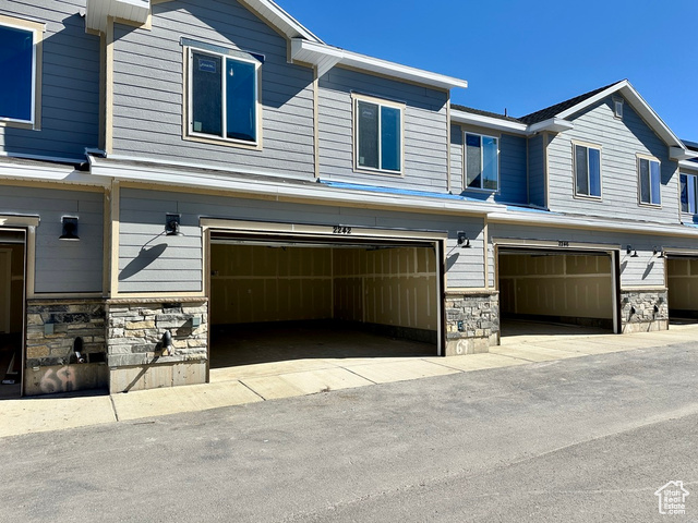 2242 South 1120 West, Unit 69 Logan, UT 84321 - Photo 4 of 26 View of property exterior with stone siding and an attached garage