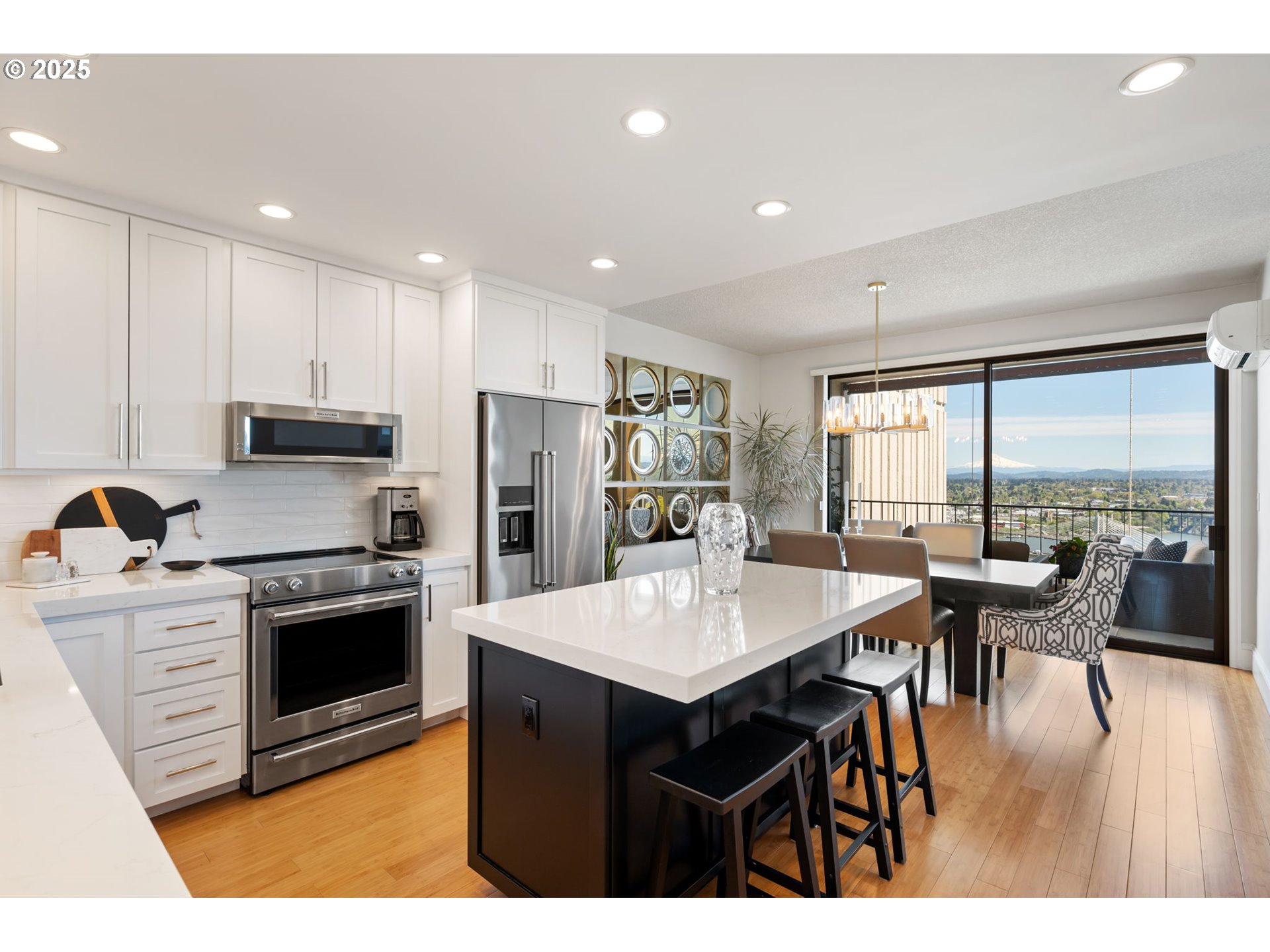 2221 Southwest 1st Avenue, Unit 2225 Portland, OR 97201 - Photo 21 of 47 a kitchen with stainless steel appliances granite countertop a stove a refrigerator a sink a dining table and chairs