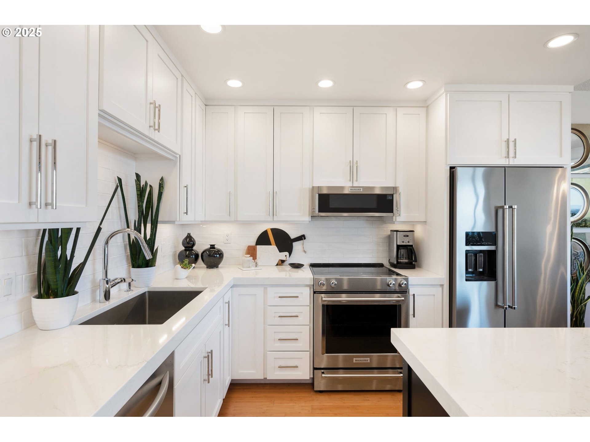 2221 Southwest 1st Avenue, Unit 2225 Portland, OR 97201 - Photo 27 of 47 a kitchen with white cabinets and stainless steel appliances