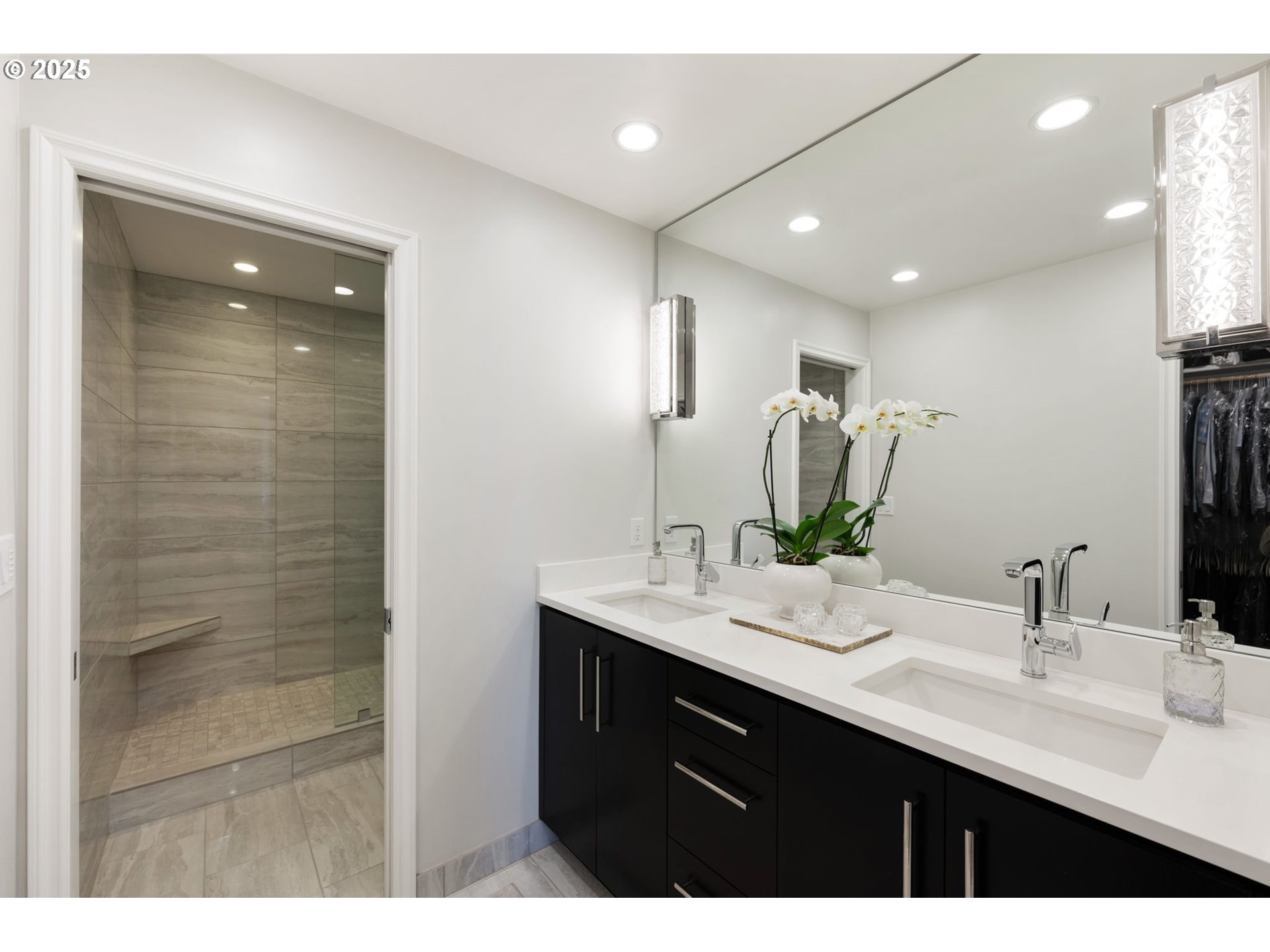 2221 Southwest 1st Avenue, Unit 2225 Portland, OR 97201 - Photo 34 of 47 a bathroom with a double vanity sink a mirror and a shower