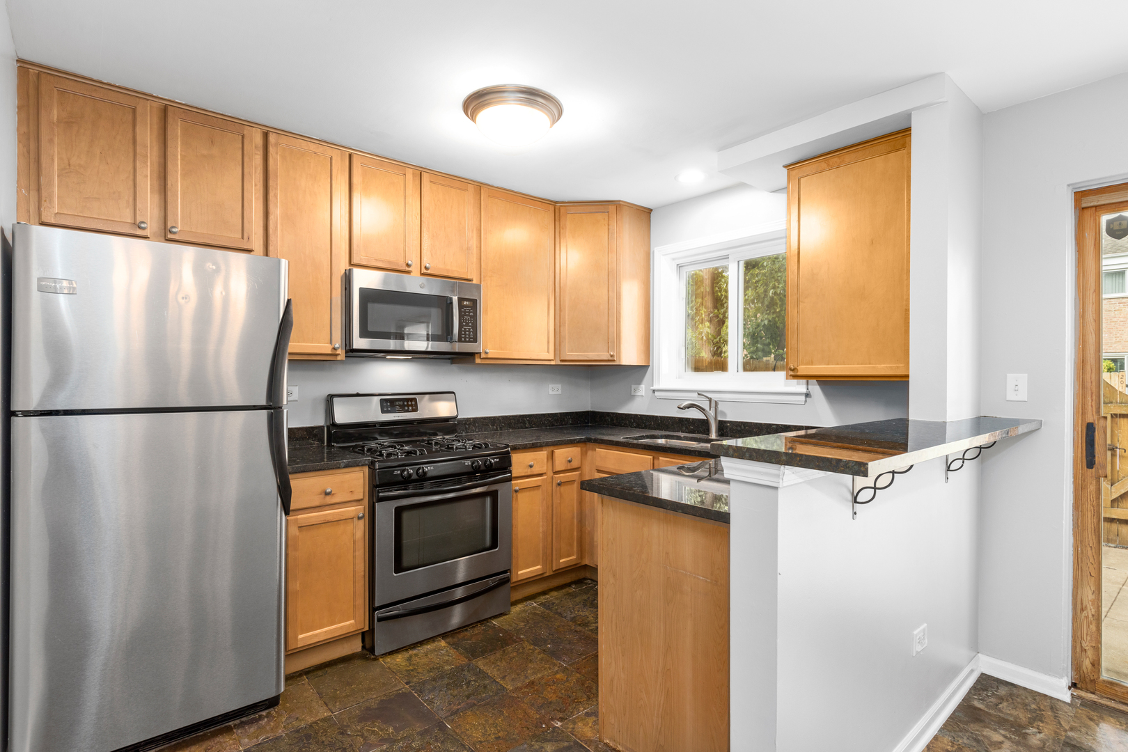 2008 Maple Avenue Northbrook, IL 60062 - Photo 2 of 16 a kitchen with stainless steel appliances granite countertop a refrigerator a stove a sink and a microwave