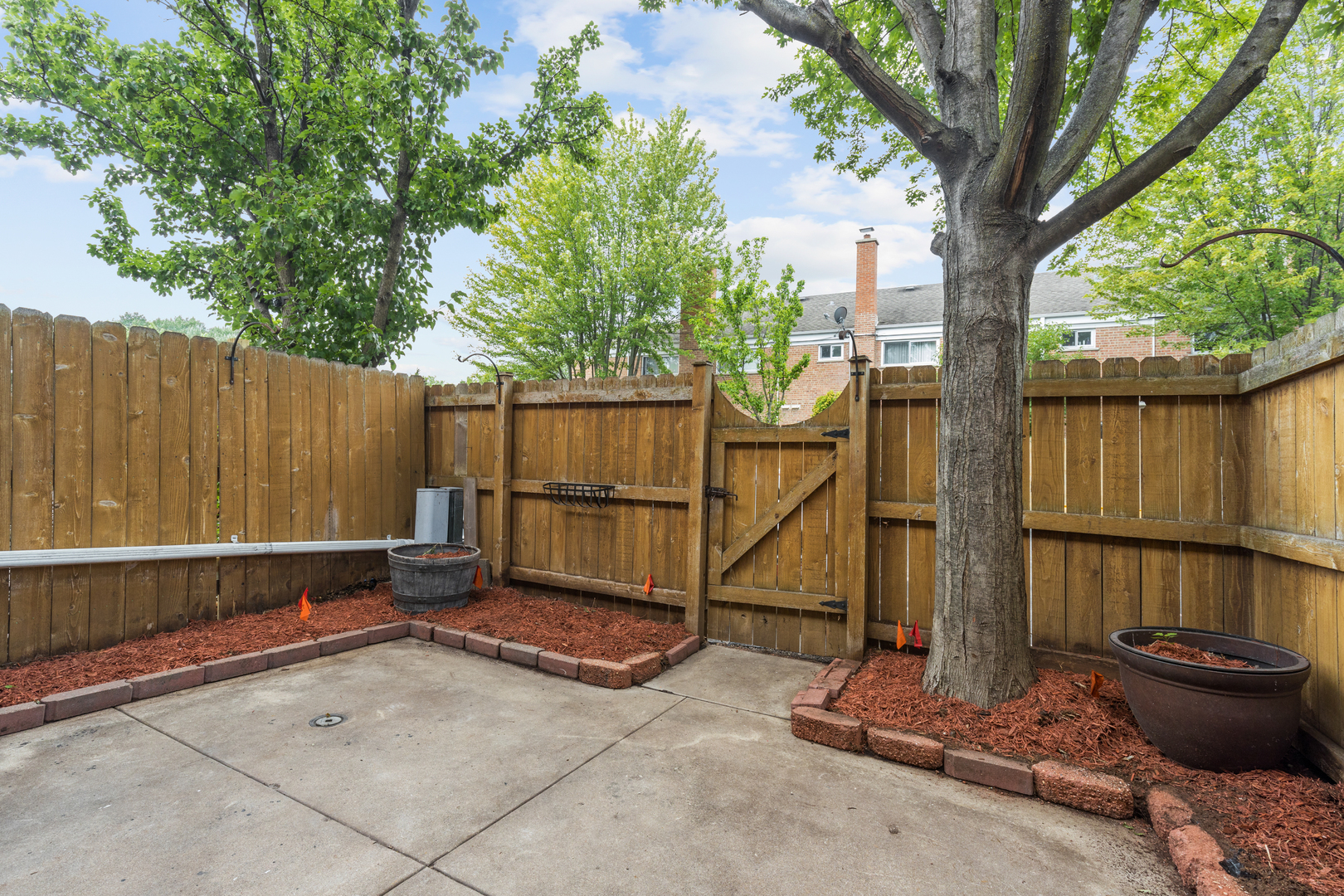 2008 Maple Avenue Northbrook, IL 60062 - Photo 16 of 16 a backyard of a house with barbeque oven and fence