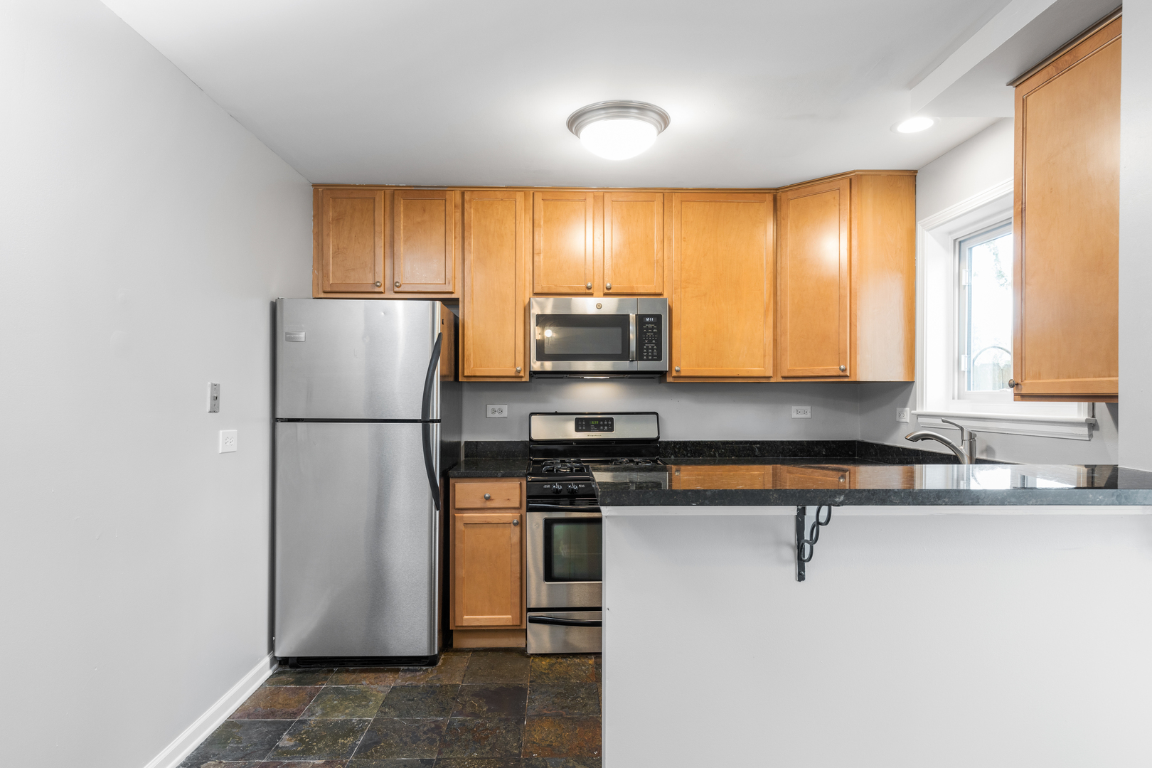 2008 Maple Avenue Northbrook, IL 60062 - Photo 4 of 16 a kitchen with a refrigerator a stove and a microwave
