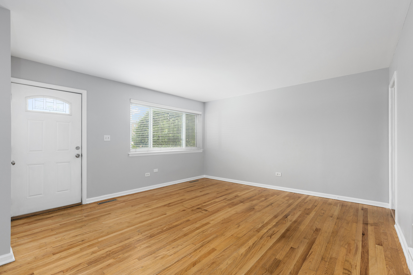 2008 Maple Avenue Northbrook, IL 60062 - Photo 7 of 16 a view of an empty room with wooden floor and a window