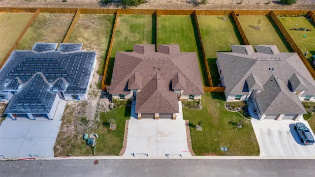 an aerial view of a house with a swimming pool