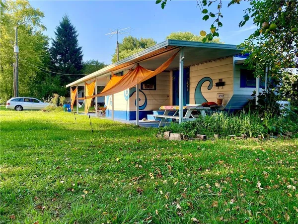 a front view of house with a garden