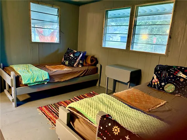 a front view of a building and trees in the background