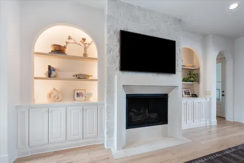 a kitchen with a dining table chairs refrigerator and wooden cabinets