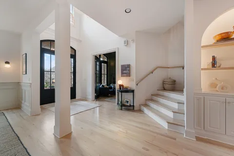 a living room with fireplace furniture and a rug