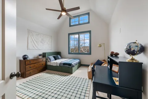 a living room with furniture a flat screen tv and a large window