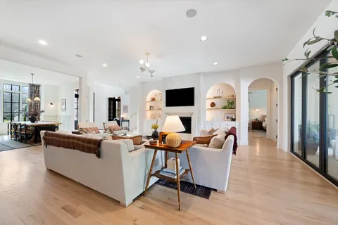 a living room with fireplace furniture and a flat screen tv
