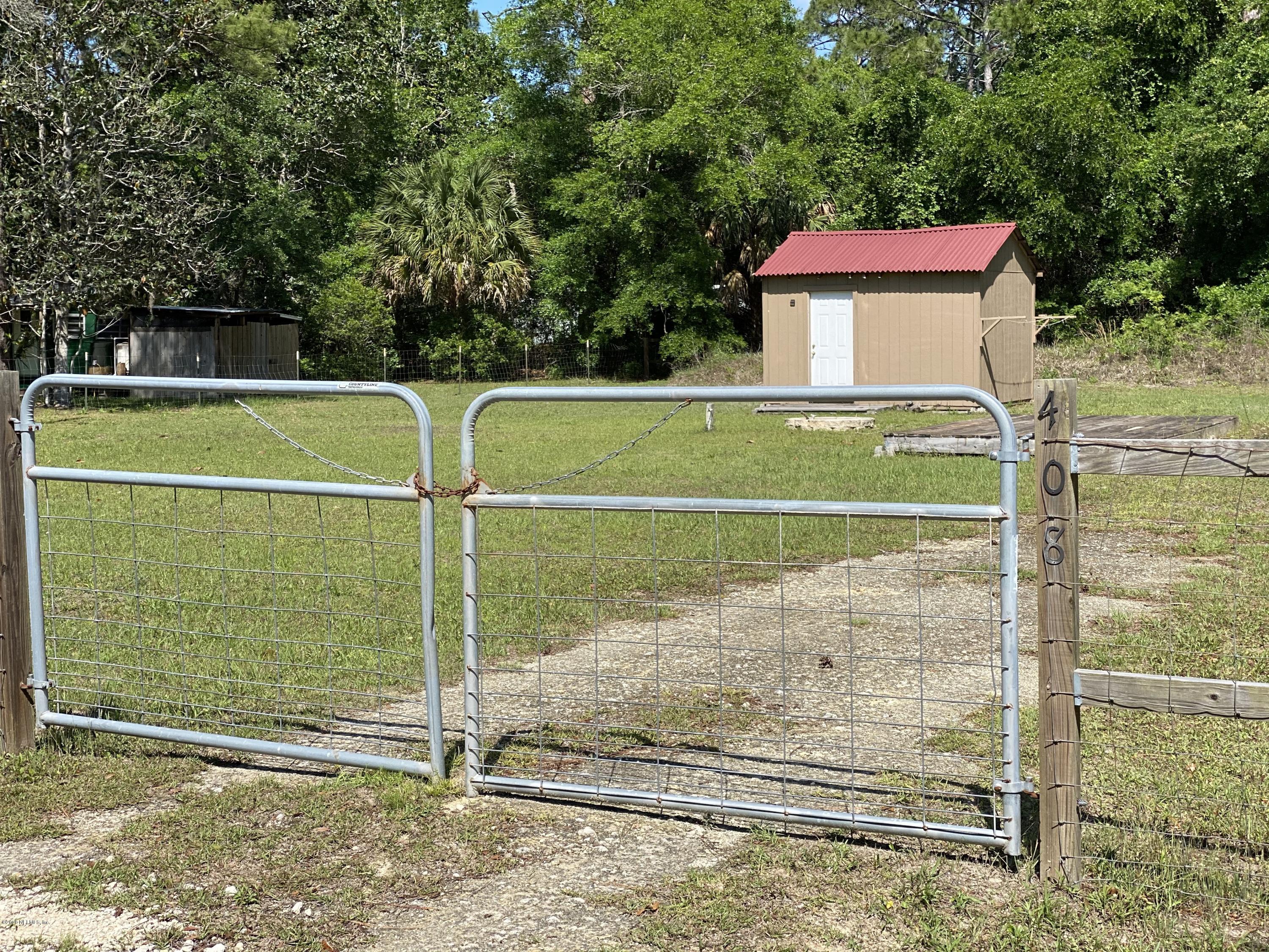 408 1st Street Steinhatchee, FL 32359 - Photo 3 of 6 a view of a tennis ground with large trees
