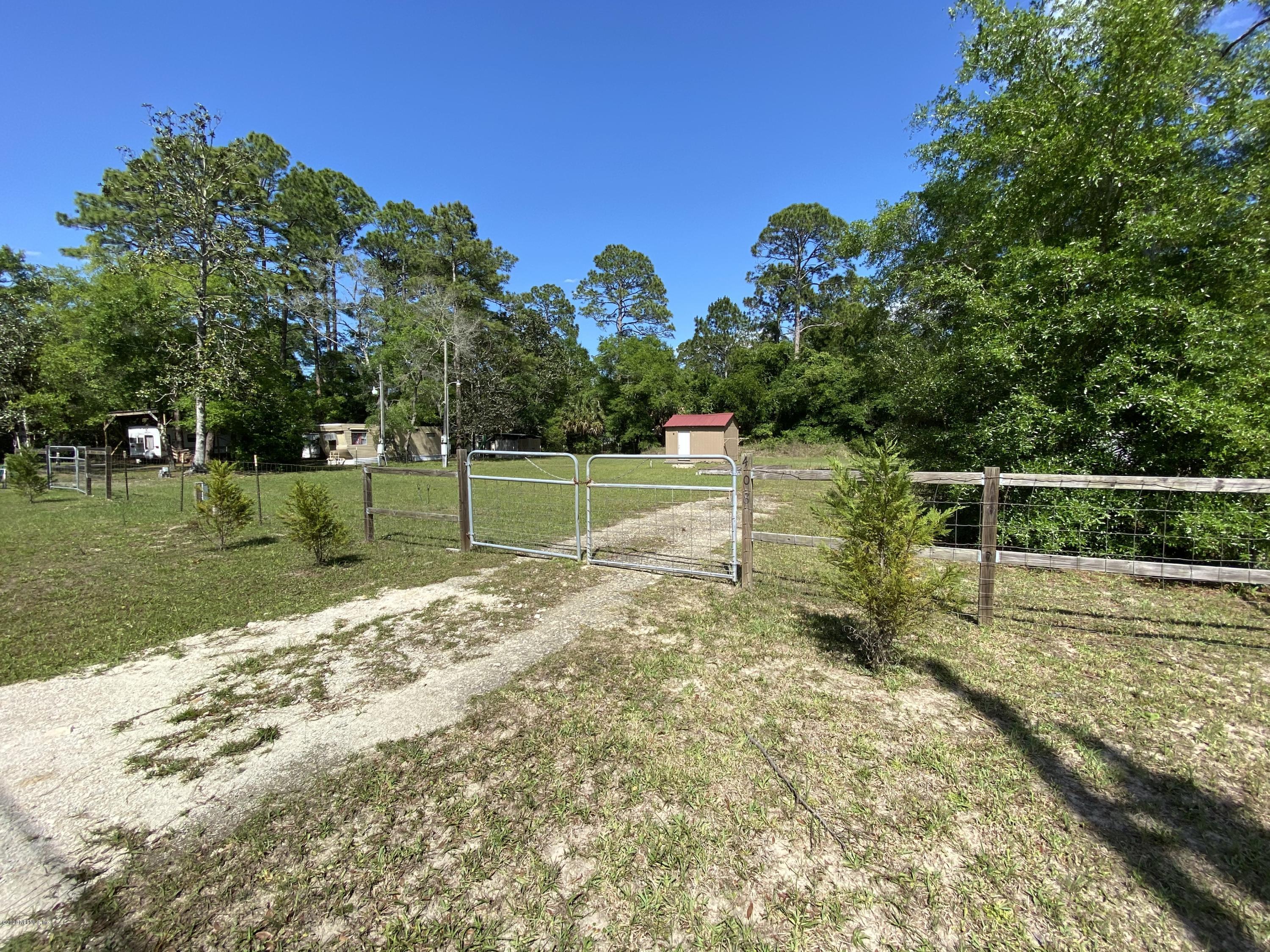 408 1st Street Steinhatchee, FL 32359 - Photo 5 of 6 a view of a yard with wooden fence