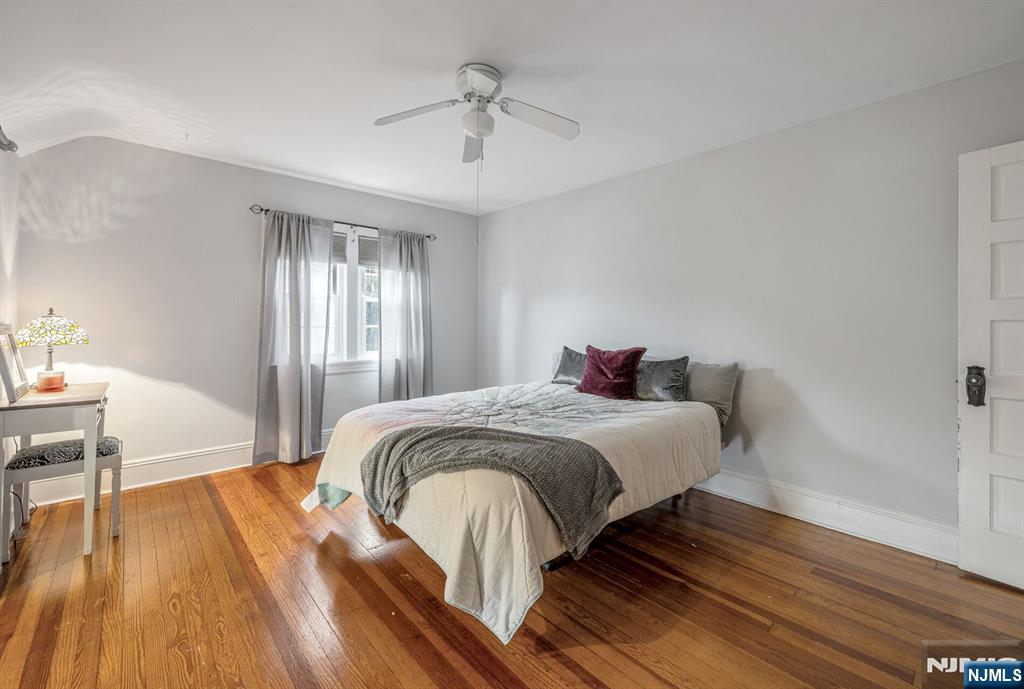 203 Long Pond Road West Milford, NJ 07421 - Photo 32 of 50 a bedroom with a bed and wooden floor