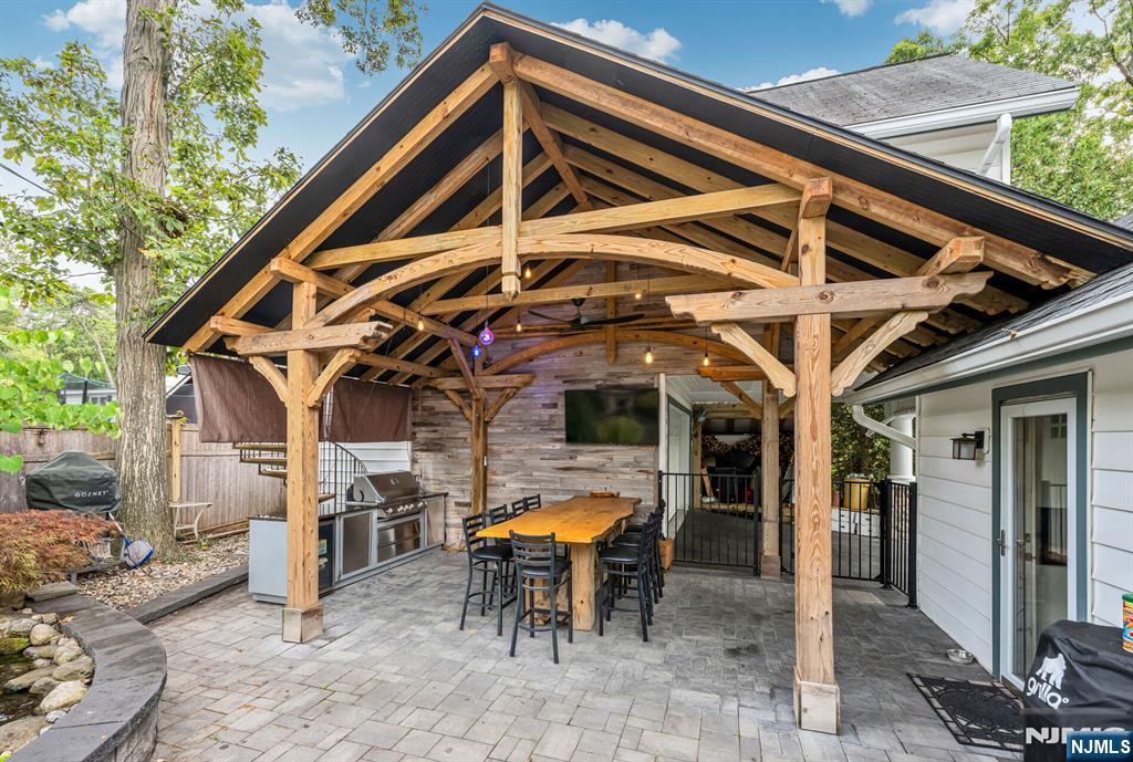 203 Long Pond Road West Milford, NJ 07421 - Photo 40 of 50 a view of a patio with table and chairs with wooden floor and fence