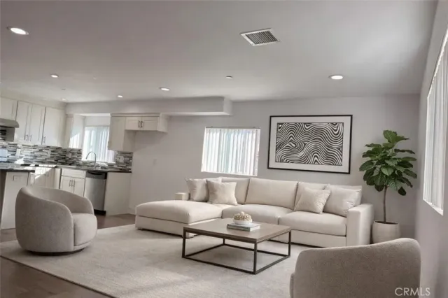 a living room with furniture and a potted plant