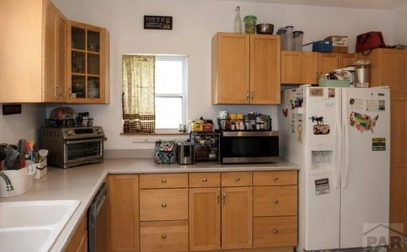 11229 County Rd JJ 5 Manzanola, CO 81058 - Photo 26 of 32 a kitchen with stainless steel appliances a sink stove and refrigerator