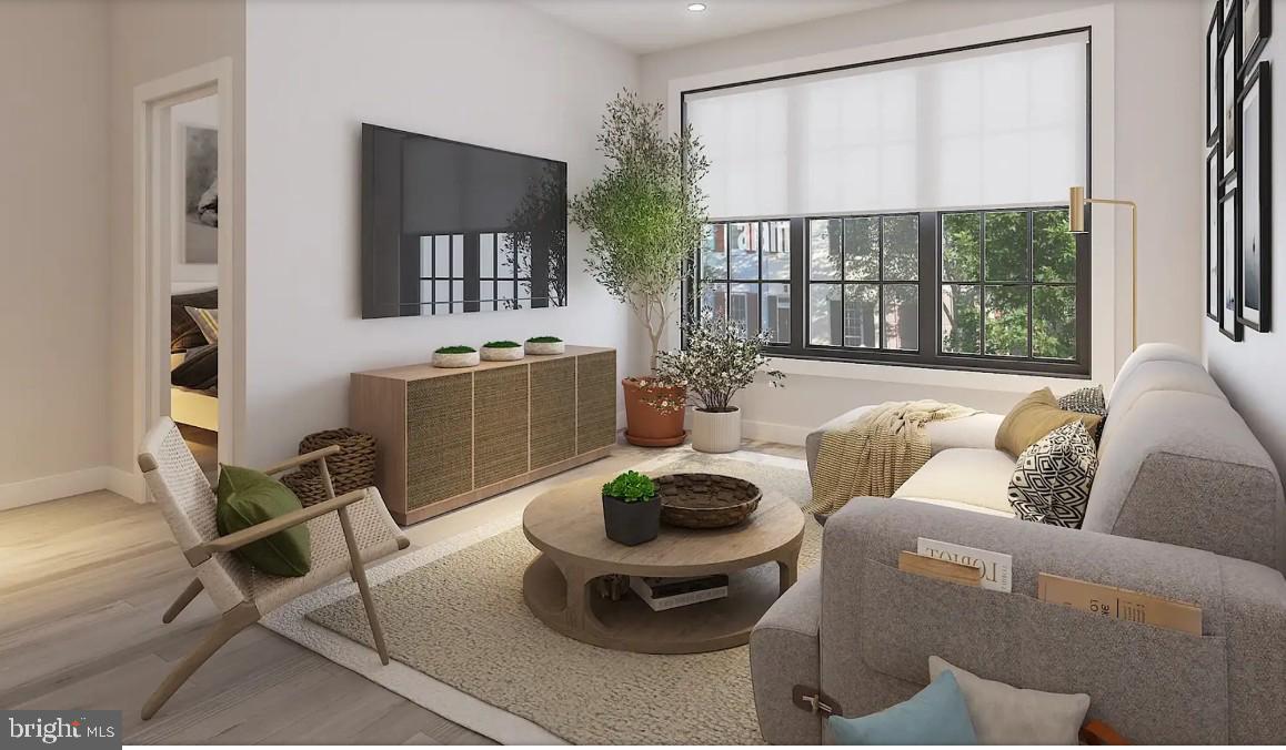 326 North 12th Street, Unit 203 Philadelphia, PA 19107 - Photo 6 of 11 a living room with furniture a table and a large window