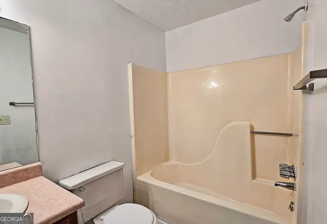 a bathroom with a bathtub and a toilet