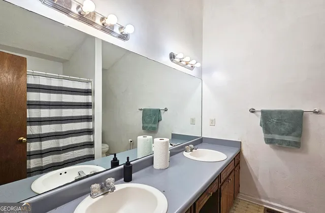 a bathroom with a sink double vanity and a mirror
