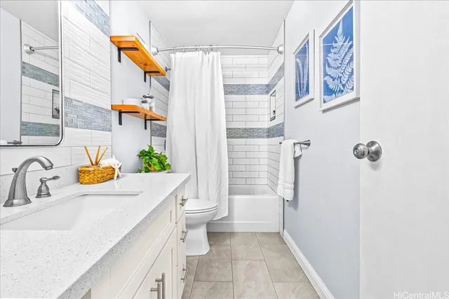 a bathroom with a sink a toilet and shower curtain