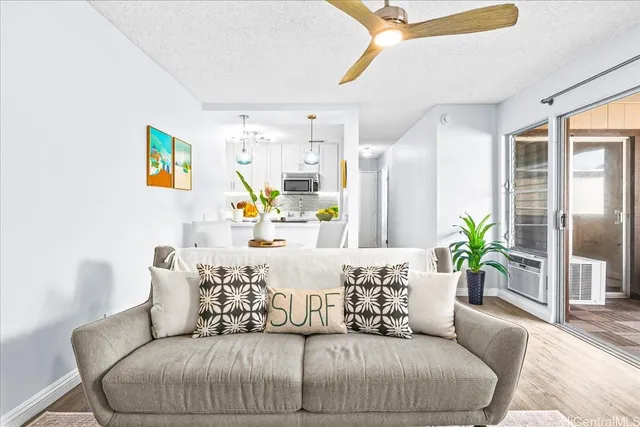 a living room with furniture and a potted plant