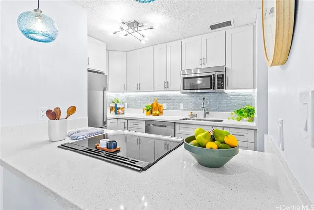 a kitchen with a sink a stove and cabinets