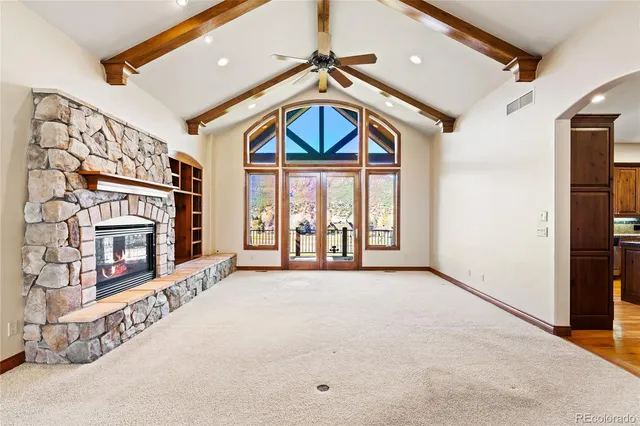 a view of a hallway with wooden floor and a staircase