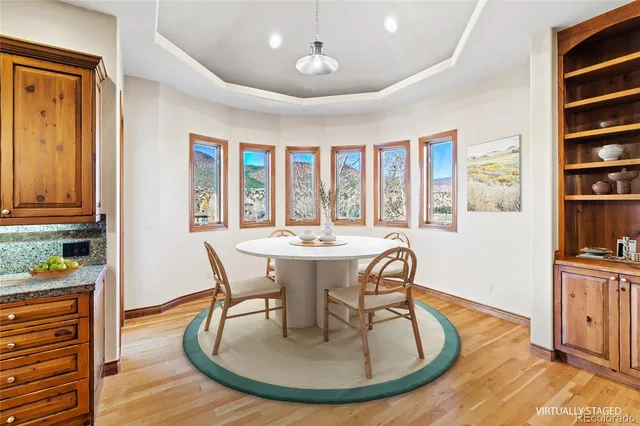 a kitchen with stainless steel appliances granite countertop a stove a sink dishwasher and a microwave oven with wooden floor