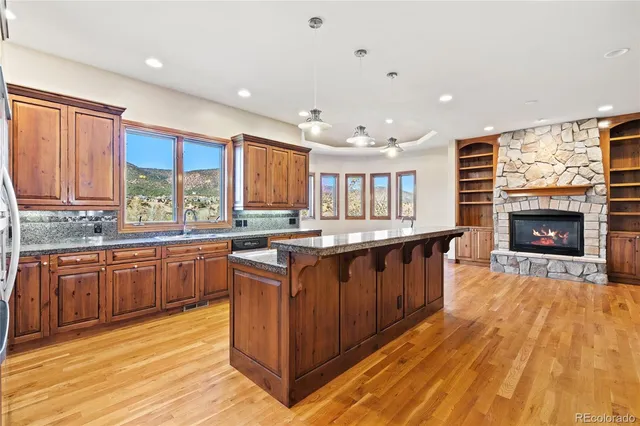 a kitchen with stainless steel appliances granite countertop a stove and a sink