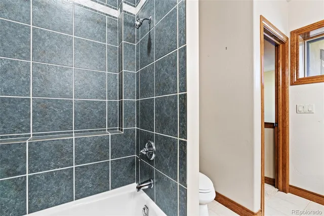 a bathroom with a granite countertop sink a large mirror and a shower